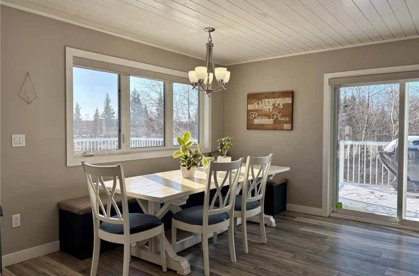 Dining area featuring ornamental molding, an inviting chandelier, wooden ceiling, and dark hardwood / wood-style flooring