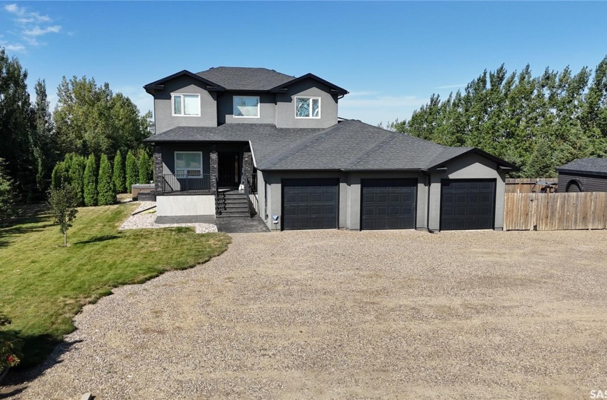 The home had new PVC windows, acrylic stucco, shingles and exterior stone work redone approximately 10 years ago. The front walk is stamped concrete leading to the covered east facing veranda. Side garage man door leading to the triple garage that is heated.