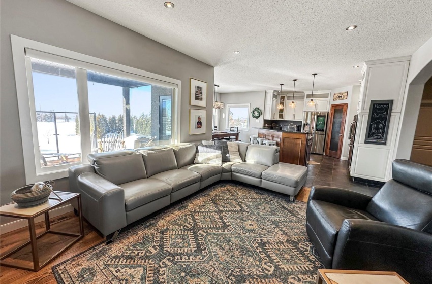 Open concept main floor with an abundance of windows to the west. The Great Room with warm oak flooring opens to the gourmet kitchen and dining area!