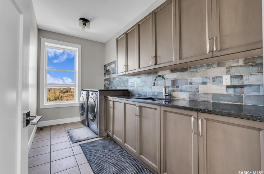 2nd floor laundry room with sink and tons of storage.