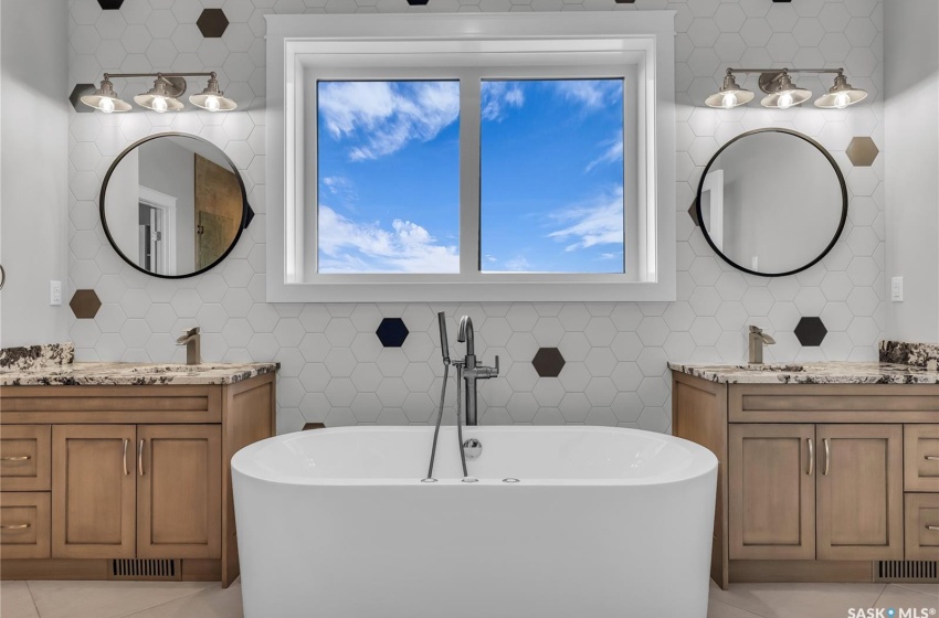 Two vanities and stand alone jet tub.