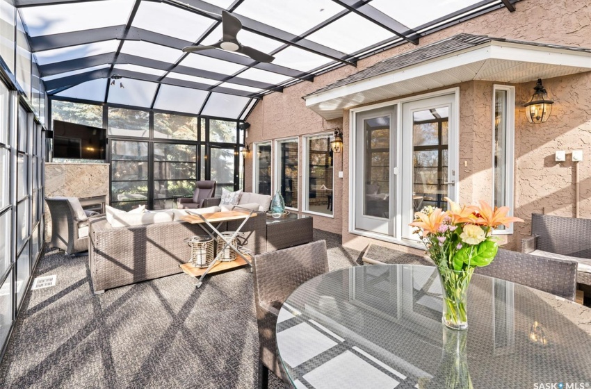 Sunroom / solarium with vaulted ceiling and a healthy amount of sunlight