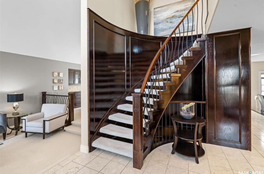 Curved stairway featuring tile patterned flooring