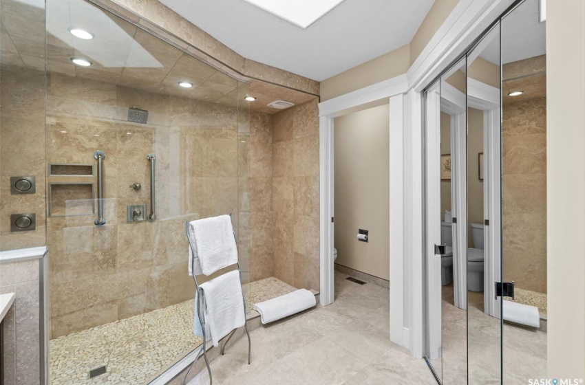 Bathroom with toilet and tiled shower