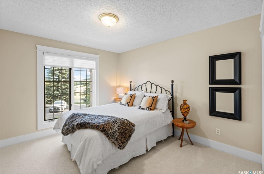 Carpeted bedroom featuring a textured ceiling