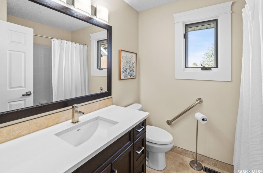 Bathroom featuring vanity, toilet, and tile patterned floors