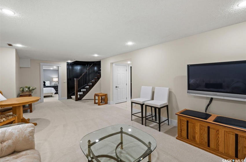 Game room with a textured ceiling and light colored carpet