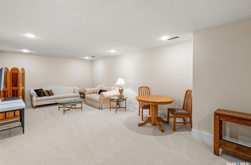 Carpeted game room featuring a textured ceiling