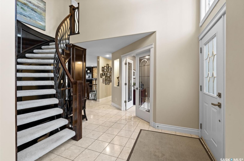 Tiled foyer entrance with french doors