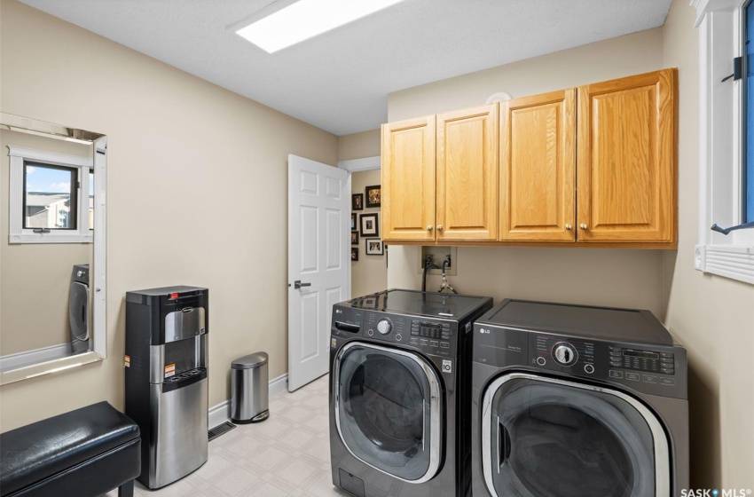 Clothes washing area with cabinets and washing machine and clothes dryer