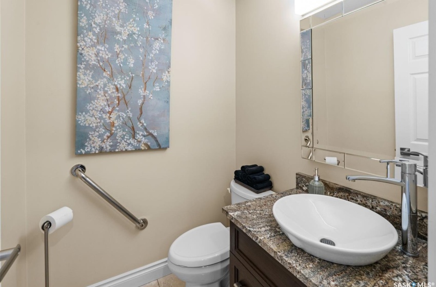 Bathroom featuring toilet, vanity, and tile patterned floors