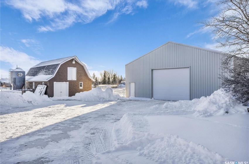 Snow covered structure with a garage