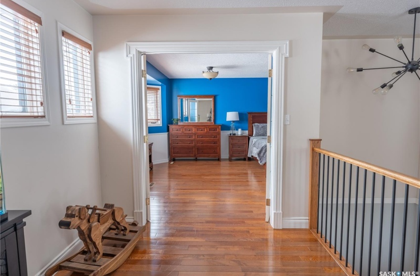 Hallway featuring wood finished floors and baseboards