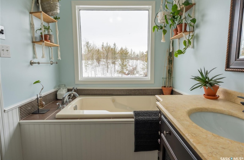 Bathroom featuring a garden tub and vanity