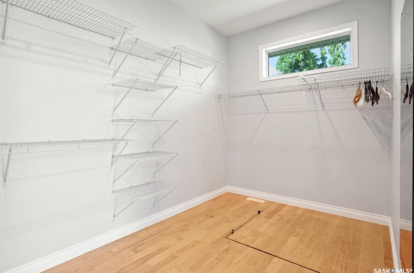 Primary walk in closet with hatch to crawlspace