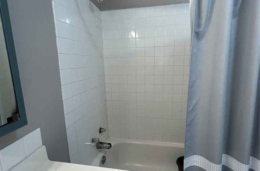 Full bath with shower / bath combo with shower curtain and vanity