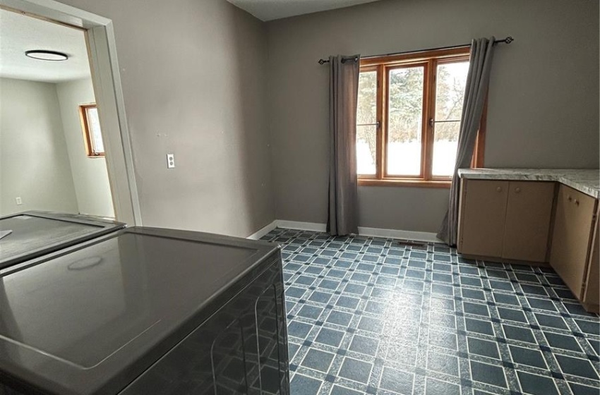 Empty room featuring a textured ceiling and baseboards