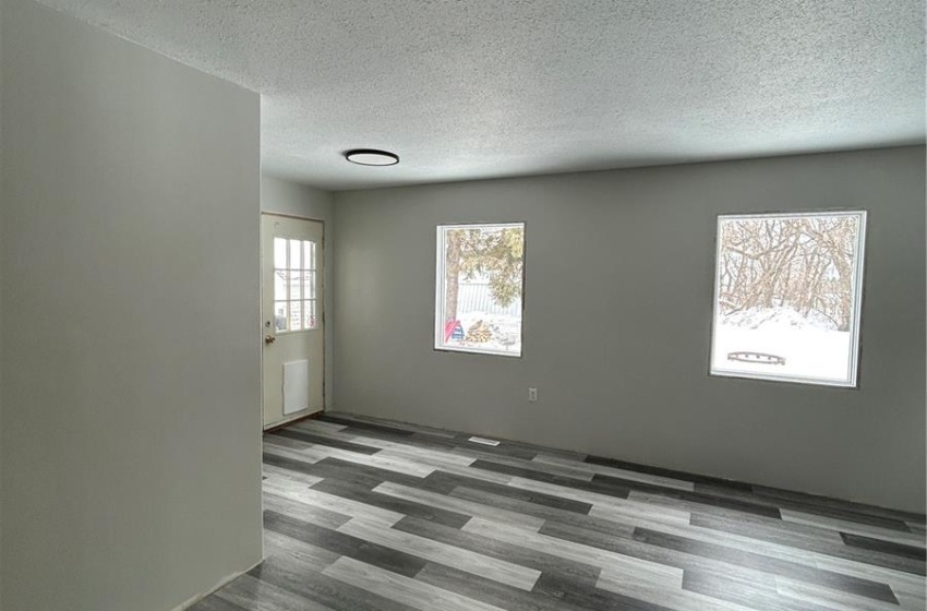 Unfurnished room featuring a textured ceiling and wood finished floors