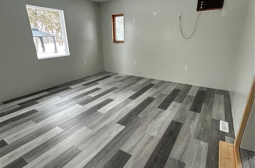 Unfurnished room featuring visible vents, a textured ceiling, and wood finished floors