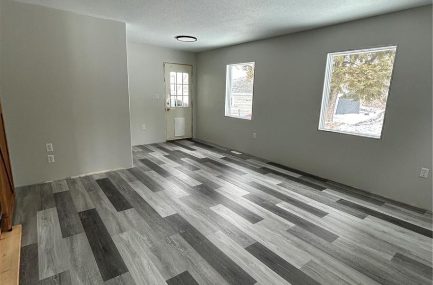 Unfurnished room featuring a textured ceiling and wood finished floors