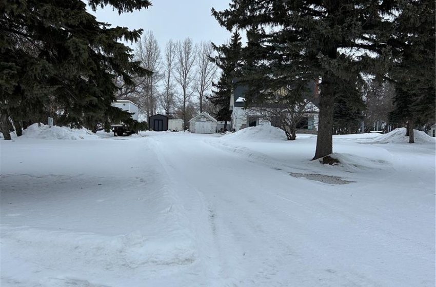 Yard covered in snow featuring a garage