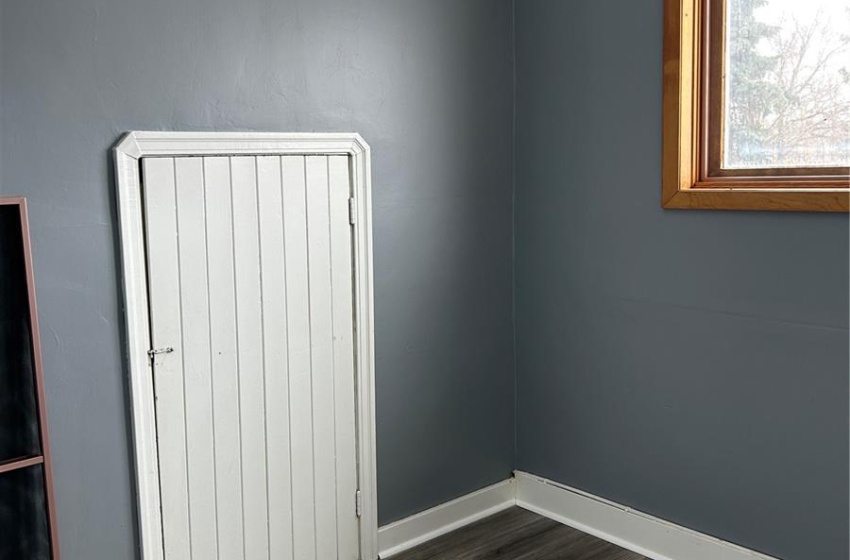 Empty room featuring baseboards and wood finished floors