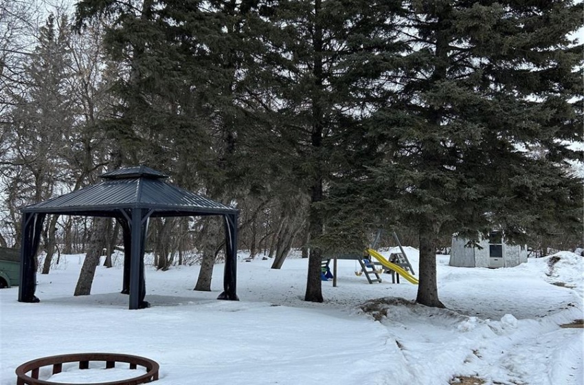 Yard layered in snow featuring a gazebo