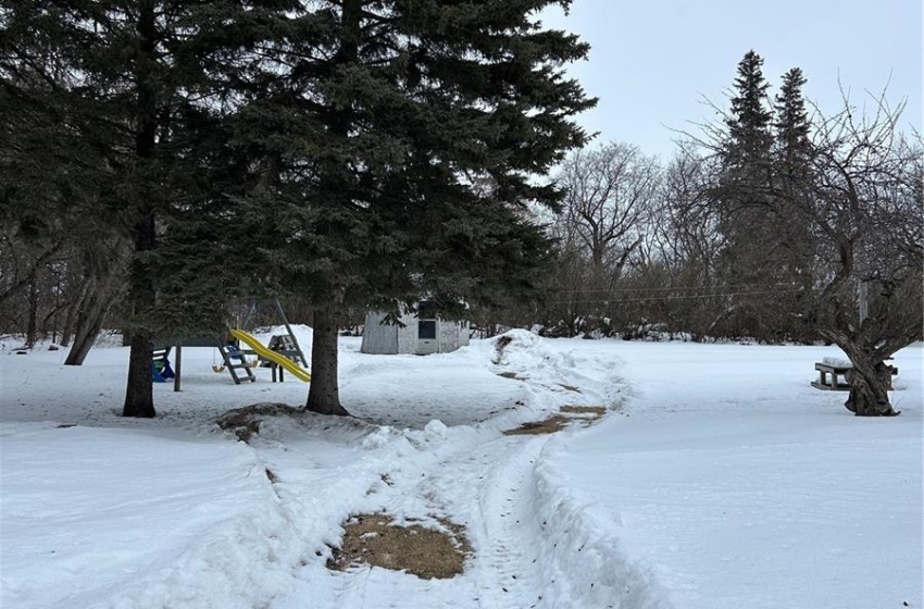 Yard covered in snow with a garage