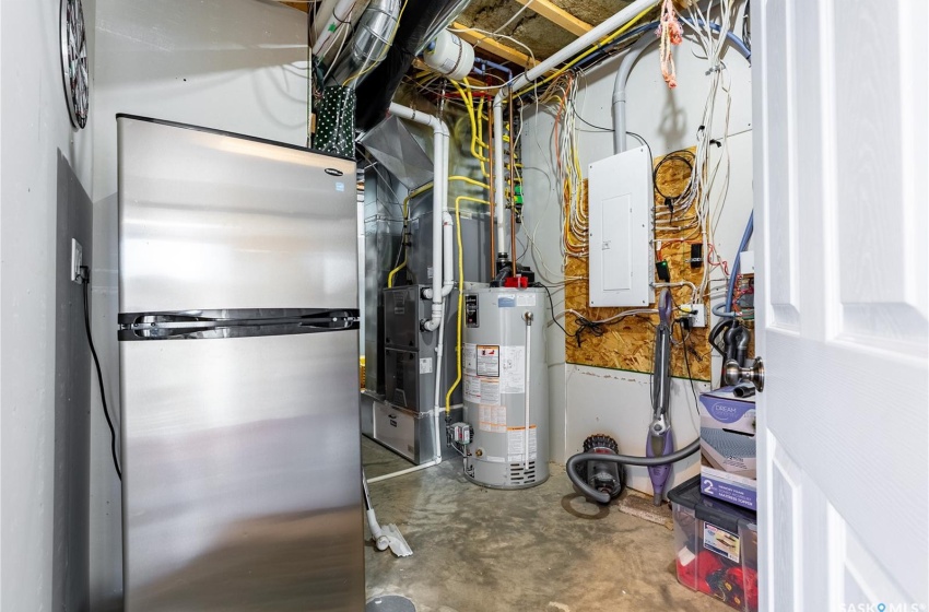 Utility room with electric panel and water heater