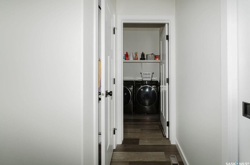 Washroom with separate washer and dryer and dark hardwood / wood-style flooring