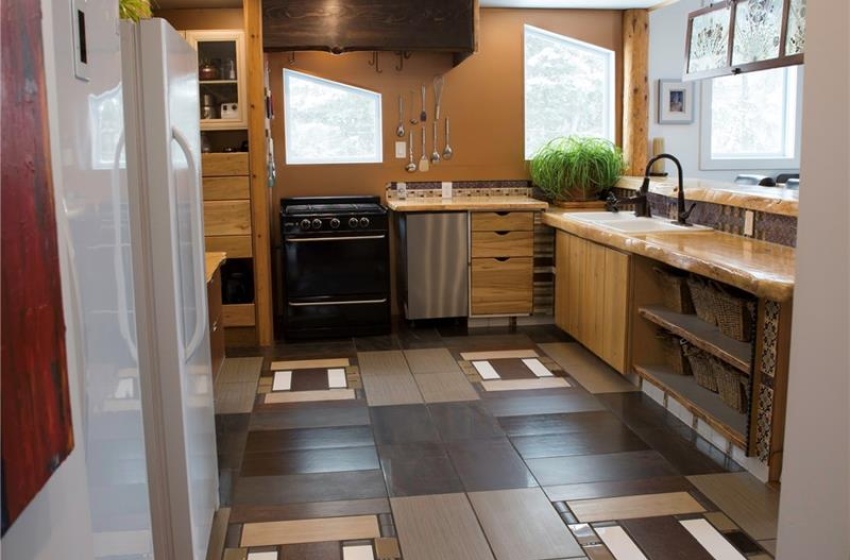 Kitchen featuring range, a sink, light countertops, stainless steel dishwasher, and recessed lighting