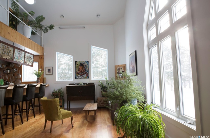 Living area with a towering ceiling and wood finished floors