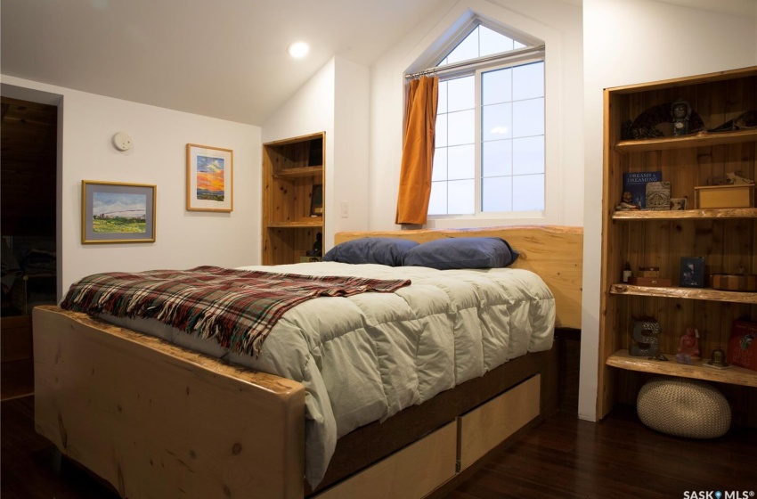 Bedroom featuring lofted ceiling and dark wood finished floors