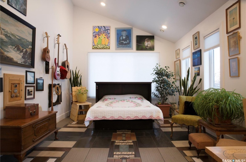 Bedroom featuring baseboards, vaulted ceiling, and recessed lighting